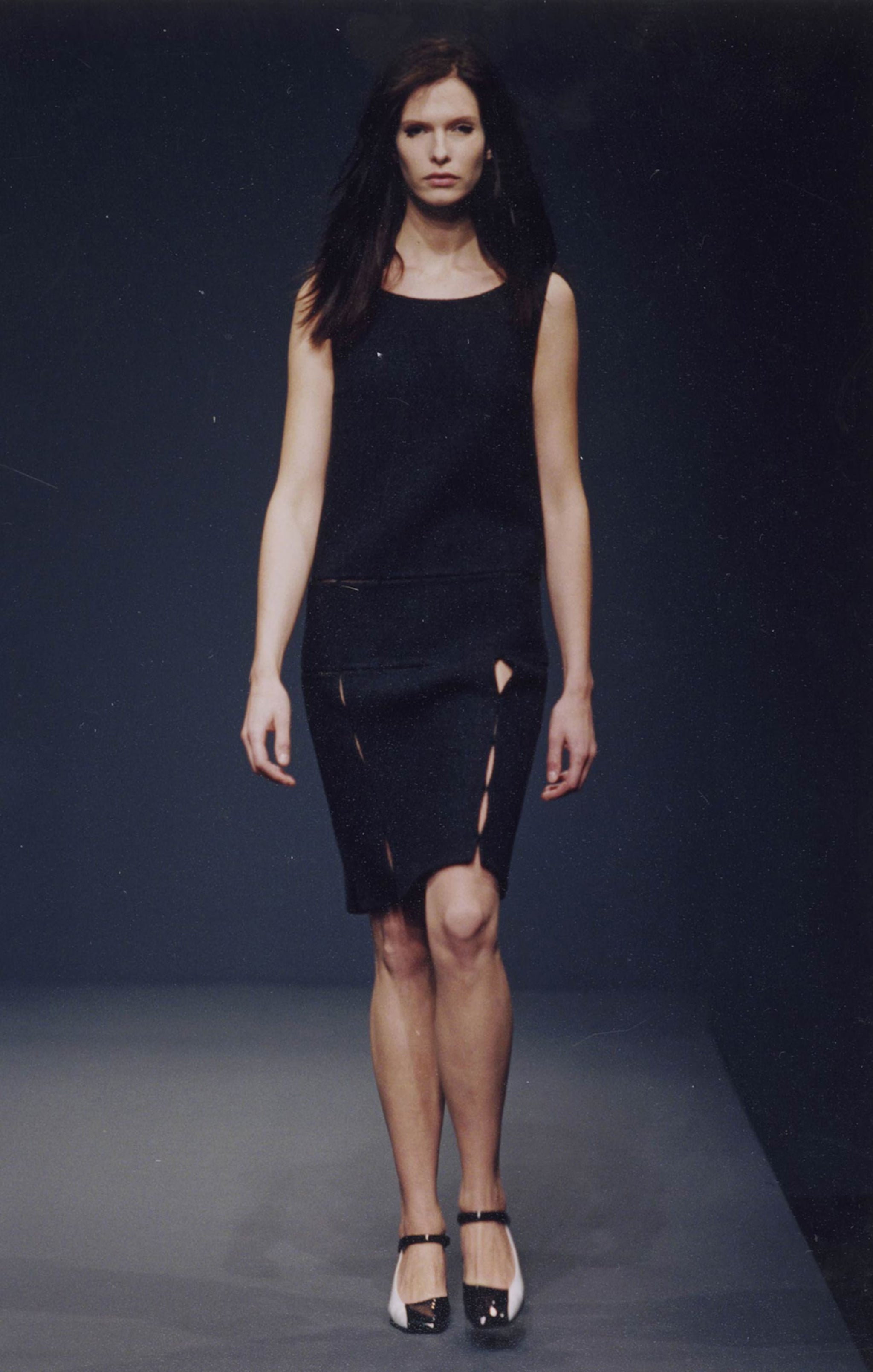 A model walks the Prada Fall/Winter 1998 womenswear show in Milan. Image via Pradasphere