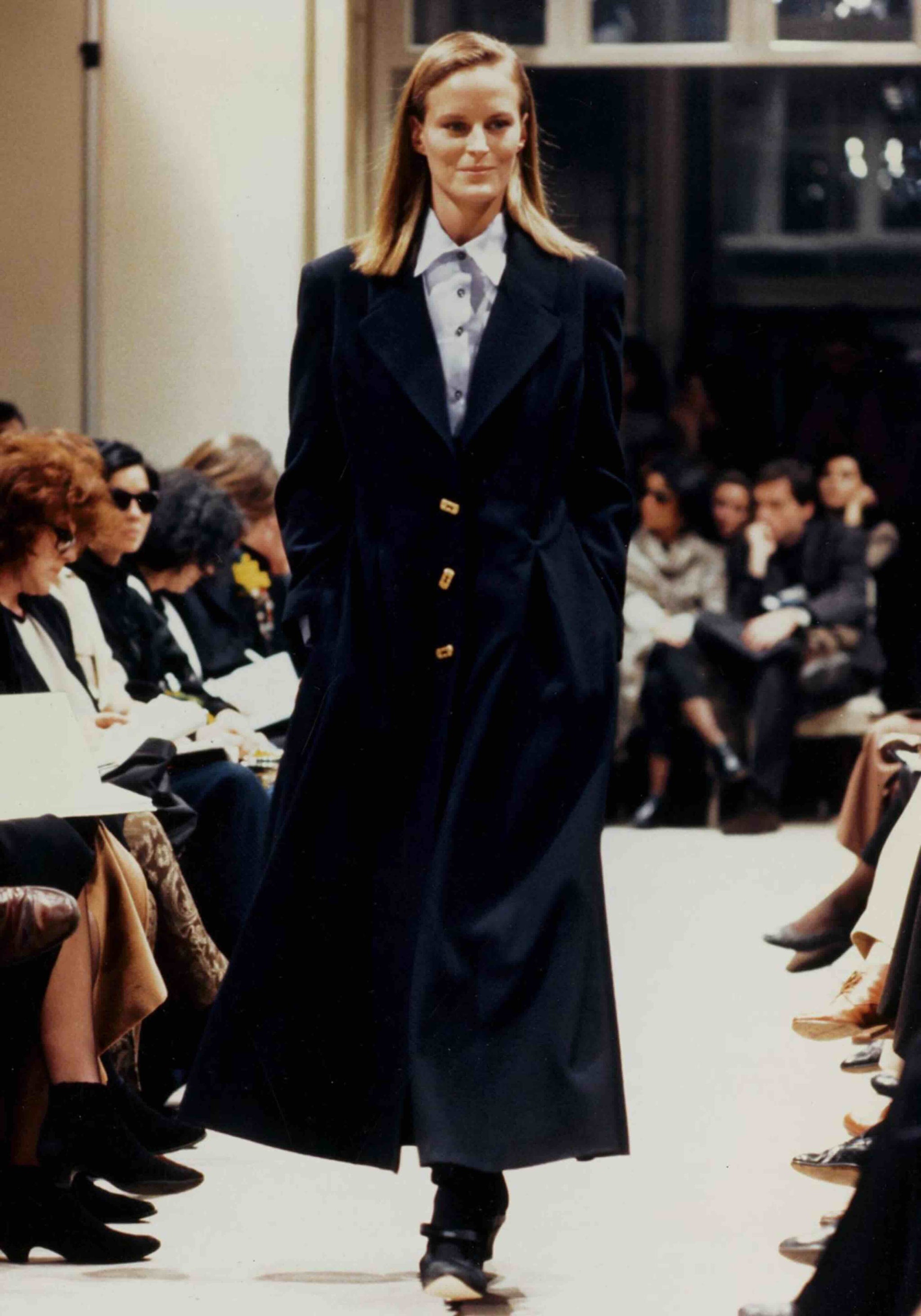 A model walks the Prada Fall/Winter 1989 womenswear show in Milan. Image via Pradasphere